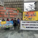 Banners at a climate justice rally. Banner read, "Green Buildings, Good Jobs, Climate & Worker Justice Now!" "They Can Afford to Pay. We Can't Afford to Wait. Electrify Now!" "Electrify Seattle: Cooling, Clean Energy, Union Jobs" "Climate Justice Now!"